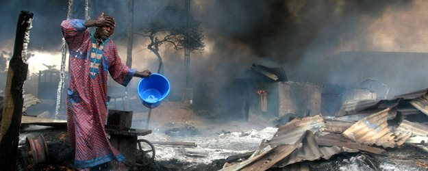 The night before, an armed gang had tapped a pipeline, which caught fire while neighbors where gathering up the leaking fuel. (photo: Akintunde Akinleye, Lagos, 2006)