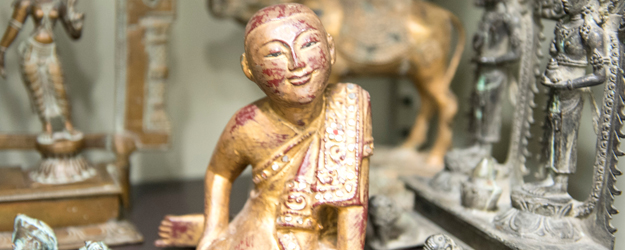 The smiling monk in gold bronze and decorated with a sort of sequins came from Burma. (photo: Peter Pulkowski)